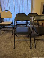 Group of five folding chairs shown together