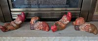 Four gnome figurines lined before fireplace