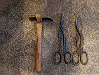 Hammer and two tin snips side by side