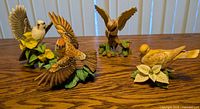 All four Lennox china bird figurines on tabletop