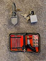 overview showing antique padlock, small padlock with keys and ratchet screwdriver kit