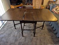 Table shown fully extended with centre leaf inserted