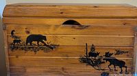 Chest front showing pine finish and wildlife artwork