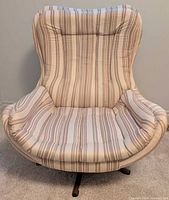 Front view of pod swivel chair showing shape and upholstery