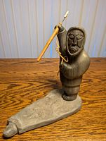 Full view of soapstone carving showing hunter, harpoon, base and seal head