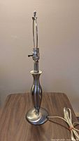 Short brushed-nickel table lamp base without shade