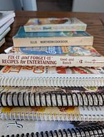 Stack showing Bisquick Impossibly Easy Pies, Northern Cookbook, Fix-It and Forget-It, spiral-bound titles