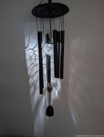Full view of hanging wind chime illuminated