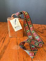 Front view of cow bell showing tag and strap