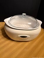 Front view showing white CorningWare slow cooker with glass lid and control panel