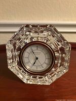Front view showing octagonal crystal body and clock face