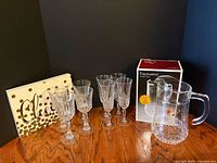 Group shot of pitcher, four goblets, boxed pitcher packaging and Cheers frame
