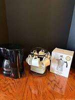 All items: drip coffeemaker, espresso cup set on rack, boxed Cafe du Chateau espresso maker
