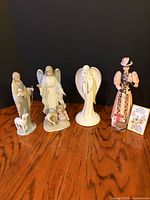 Group shot of all four porcelain figurines on tabletop