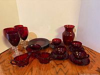 Entire ruby red glassware set displayed on table