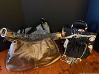 Group shot of four handbags showing styles and materials