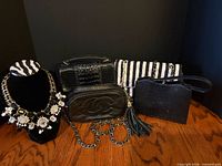 Group shot of statement necklace and five handbags