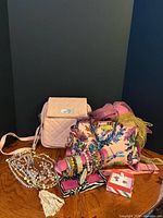 Full lot showing both handbags, scarves, bracelet roll, necklaces, brooch box