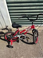 Left side view showing full bike, frame graphics, training wheels