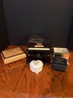 Group shot of all five musical boxes on wooden surface