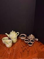 Both complete tea sets displayed