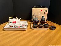 Both complete tea sets on table