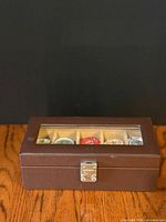 Closed brown faux leather watch case front view