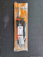 Front view of sealed package showing soldering iron, cord, and stand