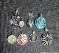 All eight pendants laid out on fabric background