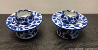 Pair of matching Delft-style blue and white porcelain candle holders, front view