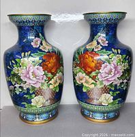 Front view of both large blue cloisonné vases with multicolor floral design
