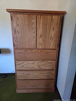 Front view doors closed showing four drawers and cabinet