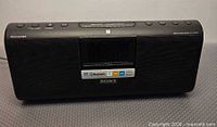 Front view of Sony ICF-CS20BT showing speaker grille, display and logos