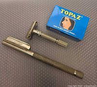 Both razors and Topaz blade pack on textured surface