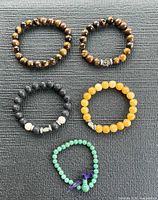 Overview of five beaded stretch bracelets