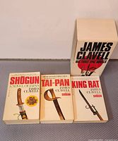Front view of the three novels alongside slipcase