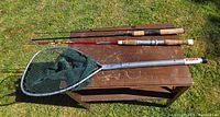 Overall view of two rods and landing net on table