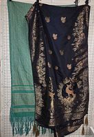 Both shawls hanging side by side for full view of colors, patterns and size