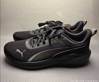 Left side profile of both shoes showing upper, laces, midsole, tag attached