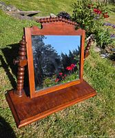 Front view of Victorian mahogany tabletop mirror showing frame, turned supports and base