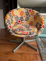 Front view of chair showing upholstery pattern and base