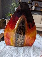 Front view of teardrop-shaped art glass vase showing color gradient and gold flecks