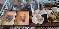 Overall lot showing dried flower pictures, cup & saucer, shakers, vase, amber glasses