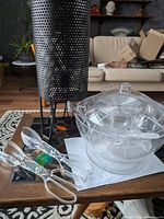 Lamp, divided bowl, lid and forks on table