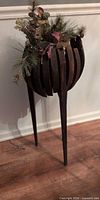 full view of wood slat planter stand with ceramic decoration inside