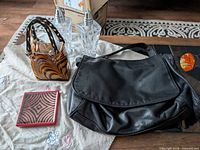 All items grouped: glass purse, crystal shakers, handkerchief, leather bag, red coaster