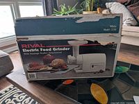 Box front displaying Rival Model 2250 electric food grinder image and text