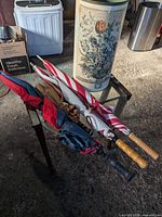 Overall view of stand and three umbrellas on table