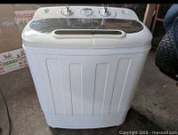 Front view of Zeny twin-tub washer spinner showing control knobs and lids