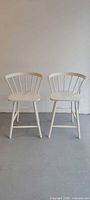Both white EQ3 chairs front view